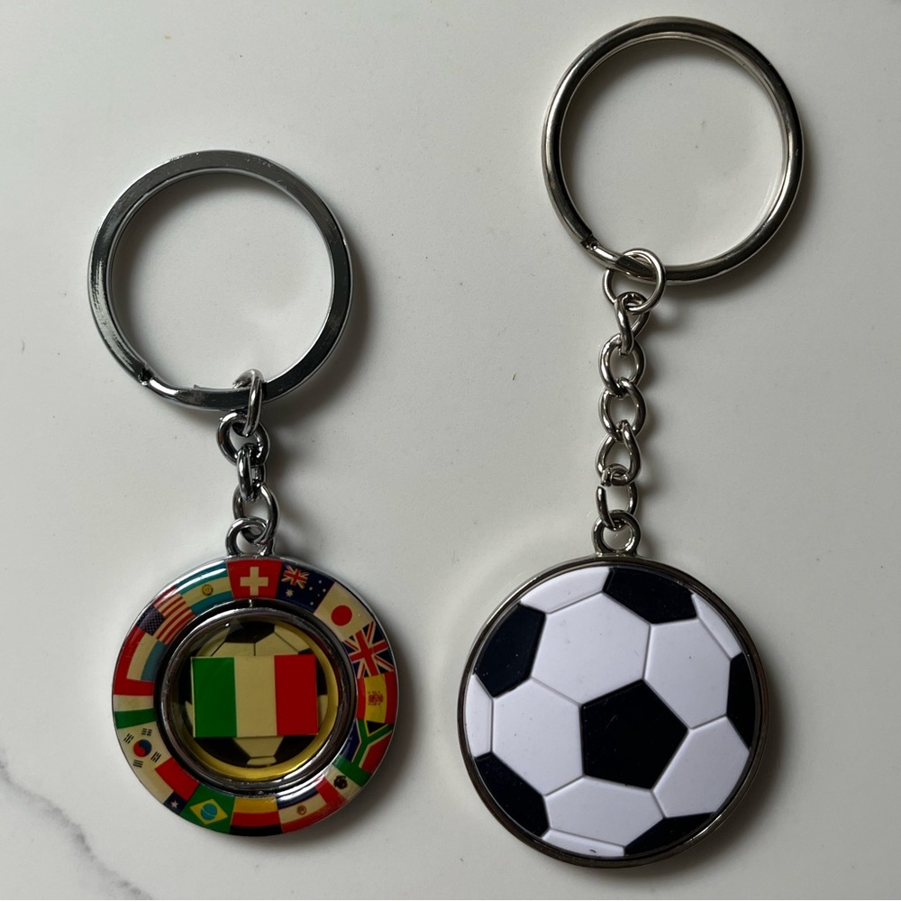 NWOT two soccer keychains. The Italian keychain flips between flag & soccer ball